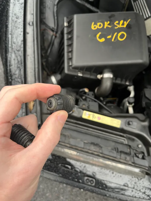 Hood stops and parking brake cable bracket — 1